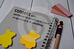 Definition of Consent word with a meaning on a book. dictionary concept