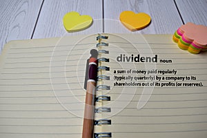 Definition of dividend word with a meaning on a book. dictionary concept