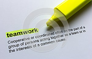Definition of teamwork, highlighted in colour. photo