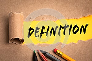 DEFINITION. Torn cardboard on a yellow background