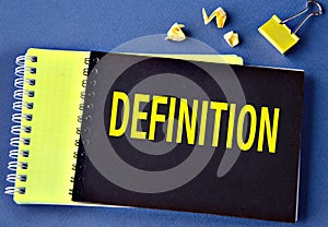 DEFINITION - word on a black notebook on a blue background