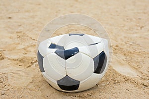 Deflated ball forgotten on the football field abandoned