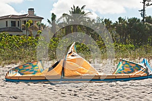 Deflated canopy for kiteboard in sand of a tropical beach photo