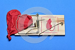 Deflated heart-shaped balloon in a mousetrap photo