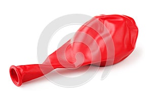 Deflated red rubber balloon photo