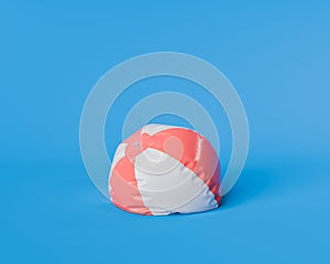 Deflated Red and White Beach Ball on Blue Background