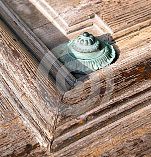 defoc knocker in a door curch closed wood lombardy italy vare