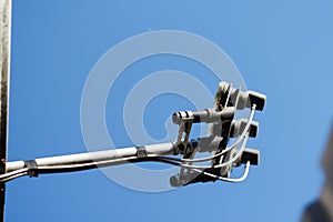 Defocus antenna against blue sky. Satellite dish on roof. White metal dish and TV receiver head to view news with