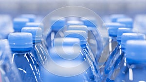 Defocus background, clean drinking water in plastic bottles. Blue background wallpaper close-up drinks