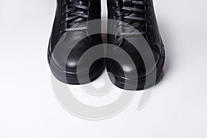 Defocus black leather male shoes, white background. Mens ankle boot leather isolated on white background, closed up
