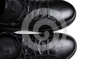 Defocus black leather male shoes, white background. Mens ankle boot leather isolated on white background, closed up