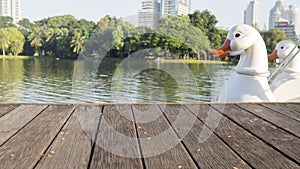 Defocus and blur image of terrace wood, white ducks and water,