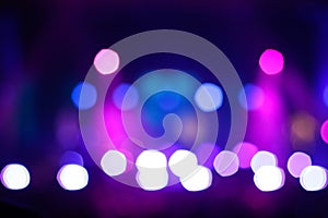 Defocus blurred abstract purple bokeh background. Rock concert performing on stage with musician with purple light on
