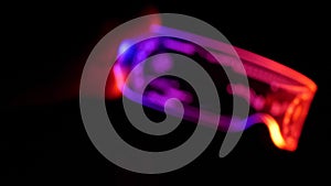 Defocus, blurred image of eyeware goggles colorful neon light, futuristic digital innovation concept, glow in dark background,