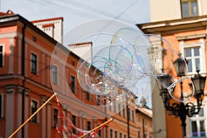 Defocus colorful bubble on city. Blowing big soap bubbles in the air. Vintage freedom, summer concepts. Blurred. Out of