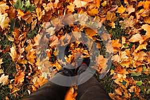 Defocus feet sneakers walking on fall leaves. Outdoor with Autumn season nature on background. Lifestyle Fashion trendy