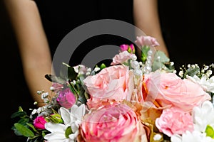 Defocus Gift box with flowers. Close up of box with pink roses in female hands. Female receive gift for mother's day