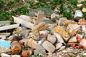 Defocus huge ruins, wreck in Ukraine, war. House after russian attack. Large garbage pile on nature green grass