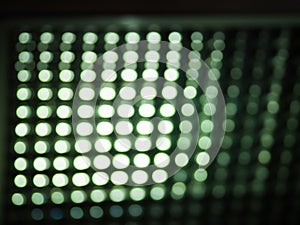 Defocus LED lamp. Glowing blurry circles on a dark green background