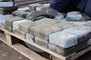 Defocus paver master. Man lays paving stones in layers. Garden brick pathway paving by professional worker. Hands of