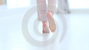Defocus, Side close up view of unrecognizable woman feet legs, barefoot girl standing indoors inside of modern home