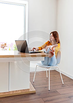 Defocus. Young woman is education online by using computer. Female freelancer browsing laptop