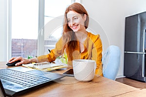 Defocus. Young woman is education online by using computer. Female freelancer browsing laptop