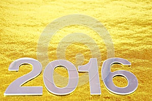 Defocused or 2016 number over golden background