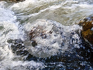 defocused abstract background of fast flowing river water