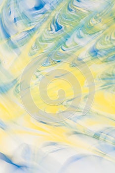 Defocused abstract background with a predominance of yellow and blue flowers, art photo