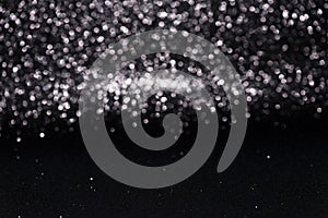 Defocused abstract black glitter with bokeh background