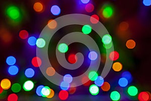 Defocused abstract christmas background of multi-colored light bulbs