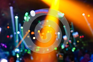 Defocused background with abstract bokeh of laser show in disco club