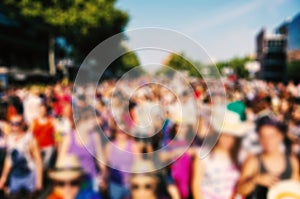 Defocused background of people partying or marching outdoors