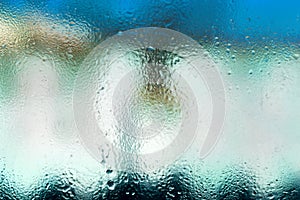 Defocused background of water droplets on glass, background photo of increased condensation
