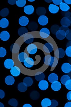 Defocused of blurred blue bokeh circle light from lighting bulb in the night for abstract background texture