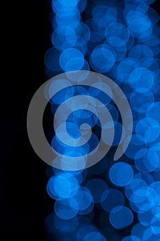 Defocused of blurred blue bokeh circle light from lighting bulb in the night for abstract background texture