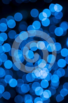 Defocused of blurred blue bokeh circle light from lighting bulb in the night for abstract background texture