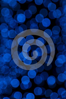 Defocused of blurred blue bokeh circle light from lighting bulb in the night for abstract background texture