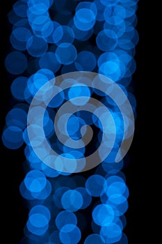 Defocused of blurred blue bokeh circle light from lighting bulb in the night for abstract background texture