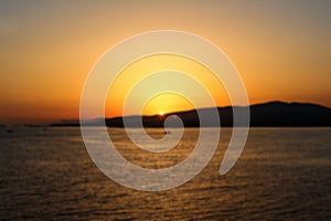Defocused bright orange sunset in a clear sky over the sea in the resort town of Gelendzhik.