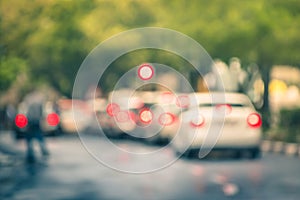 Defocused cars in city traffic jam in a rainy day