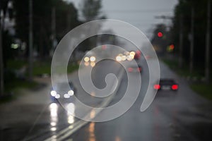 defocused cars on road at summer heavy rain