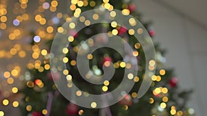 defocused Christmas lights on decorated Christmas tree blurred x-mas background