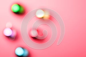 Defocused Christmas New Year composition. Gifts, colorful ball decorations on pink background