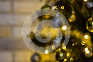 Defocused Christmas tree garland illumination. Blurred sparkling fairy background. Silver and gold lights, bokeh effect