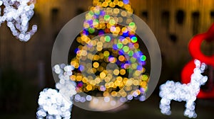 Defocused of Christmas tree lights and deers light, fairy lights, wintertime