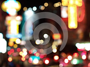 defocused colorful car lights and street lamp and signboard lights of stores building bokeh