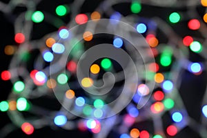 Defocused colorful garland on a black background