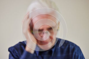 Defocused Concept Shot Of Senior Man Suffering With Mental Health Issues Like Dementia Or Alzheimers